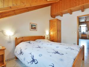 a bedroom with a large bed in a room at Apartment Villa Placidia Apt 31 by Interhome in Campitello di Fassa