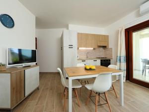 kuchnia i jadalnia ze stołem i krzesłami w obiekcie Apartment Panorama 2 by Interhome w mieście Budoni