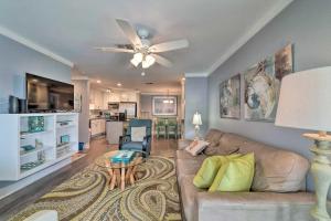 a living room with a couch and a ceiling fan at Coastal Condo with Outdoor Pool - Pets Welcome! in Mustang Beach