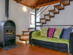 a living room with a couch and a wood stove at Holiday Home Rustico al Campett by Interhome in Ponto Valentino