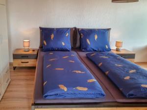 a bed with a blue comforter with fish on it at Apartment Winterhalder by Interhome in Eisenbach