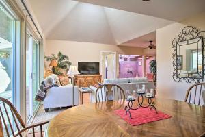 a dining room with a table and a couch at Quaint Rancho Mirage Condo with Private Patio! in Rancho Mirage