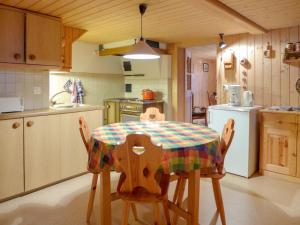 a kitchen with a table and chairs in a kitchen at Holiday Home Chalet Esther by Interhome in Brienz