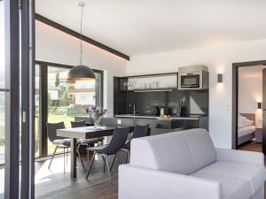 a kitchen and living room with a table and chairs at Apartment Oberhofer-5 by Interhome in Telfes im Stubai