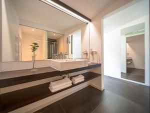 a bathroom with a sink and a large mirror at Apartment Oberhofer-5 by Interhome in Telfes im Stubai