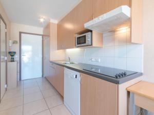 a kitchen with a sink and a microwave at Apartment Firenze 108 with parking by Interhome in Bredene