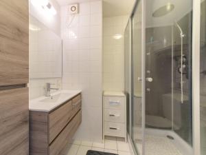 a bathroom with a shower and a sink and a tub at Apartment Firenze 108 with parking by Interhome in Bredene