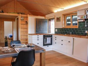 a kitchen with a table and chairs in a room at Holiday Home Rustico Rudico by Interhome in Semione
