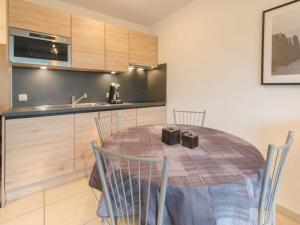 a kitchen with a table and chairs in a room at Studio Deauville II 010 with parking by Interhome in Bredene