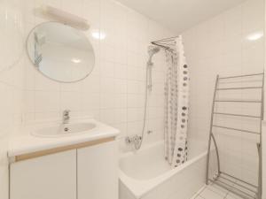 a white bathroom with a sink and a shower at Studio Deauville II 010 with parking by Interhome in Bredene