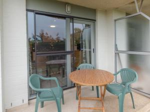a table and chairs on a porch with a table at Studio Deauville II 010 with parking by Interhome in Bredene