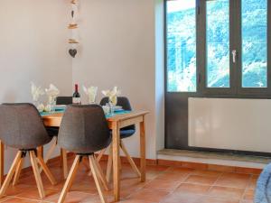 a dining room with a table and chairs and a tv at Holiday Home Rustico Ca' di Garoi by Interhome in Malvaglia