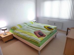 a bedroom with a bed with towels on it at Apartment Miremont B7 by Interhome in Crans-Montana