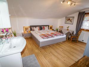 een slaapkamer met een bed, een wastafel en een bad bij Apartment Weiherwirt by Interhome in Haslach