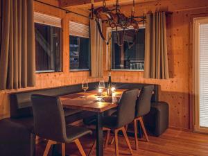 a dining room with a wooden table and chairs at Chalet Panorama by Interhome in Klippitztorl +40 photos