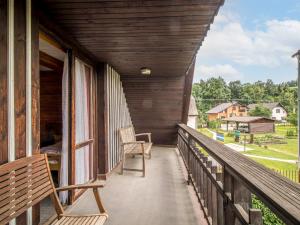 a porch with two chairs and a view of a yard at Holiday Home Lánov by Interhome in Horní Lánov +37 photos