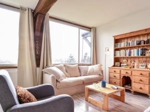 a living room with a couch and a table at Apartment La Pinchonnière-5 by Interhome in Tourgeville