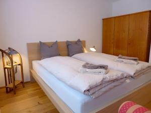 a bedroom with a bed with towels on it at Apartment Matte - Alte Post by Interhome in Schwenden