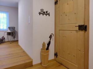 a room with a door and a broom in a trash can at Apartment Matte - Alte Post by Interhome in Schwenden +25 photos