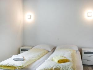 a bedroom with two beds with white sheets and towels at Apartment App- Vira Lago 500 Ost - EG by Interhome in Vira