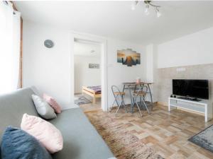 a living room with a couch and a table at Holiday Home Cherry by Interhome in Fonyód