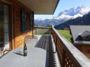a bottle of wine sitting on a table on a balcony at Apartment Le Hameau des Crosets by Interhome in Les Crosets