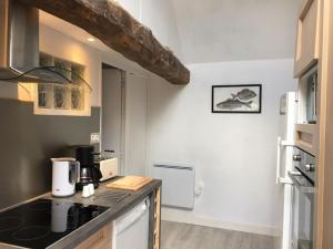 a kitchen with a counter with a coffee maker on it at Le Penty in Guimaëc