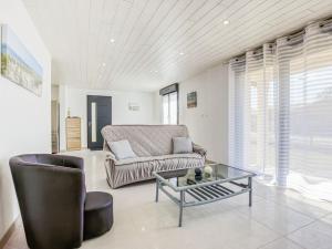 a living room with a couch and a glass table at Holiday Home Peyroutic by Interhome in Aureilhan +25 photos