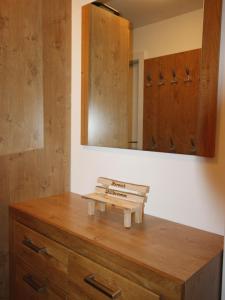 ein Badezimmer mit einer Holzkommode und einem Spiegel in der Unterkunft Apartment Tom & Jeri by Interhome in Kaprun