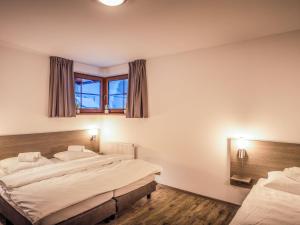 A bed or beds in a room at Holiday Home Residence Lipno by Interhome