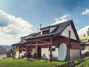 a large wooden house with a roof at Holiday Home Residence Lipno-2 by Interhome in Lipno nad Vltavou