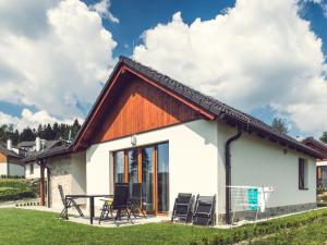 a small house with a wooden roof at Holiday Home Residence Lipno-1 by Interhome in Lipno nad Vltavou
