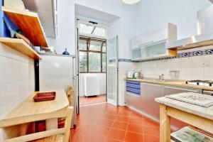 a kitchen with white appliances and a wooden table at Clodia in Rome