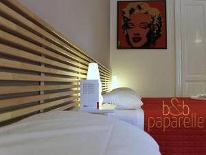 a bedroom with a bed with a sign on it at B&B Paparelle in Cosenza