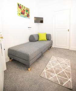 a bed in a room with a yellow pillow on it at The Tiger Inn in Merthyr Tydfil