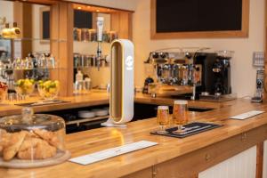 a bar with a counter with glasses of wine at The Tiger Inn in Merthyr Tydfil