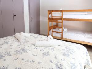 a bedroom with two bunk beds with towels on a bed at Apartment Derborence 28 by Interhome in Nendaz