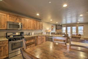 a kitchen with wooden cabinets and a large wooden table at Chic Eden Condo with Balcony and Updated Interior in Eden