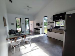 a kitchen and dining room with a table and chairs at CASA NOVA 2 in São José da Coroa Grande