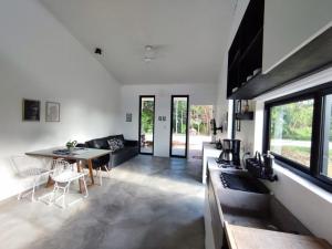 a kitchen and living room with a table and chairs at CASA NOVA 2 in São José da Coroa Grande
