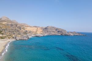 an aerial view of a beach and the ocean at Mythos Apartments in Damnoni
