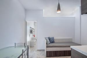 a living room with a couch and a table at Mythos Apartments in Damnoni