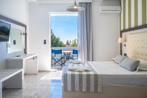 a bedroom with a bed and a balcony at Mythos Apartments in Damnoni