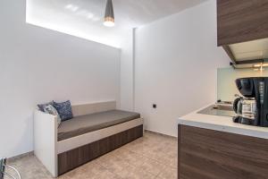 a kitchen with a bench in the corner of a room at Mythos Apartments in Damnoni