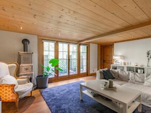a living room with a couch and a table at Apartment Chalet le Riad des Neiges a- Sauna by Interhome in Val-d'Illiez