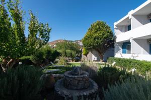a garden in front of a building at Mythos Apartments in Damnoni +20 photos