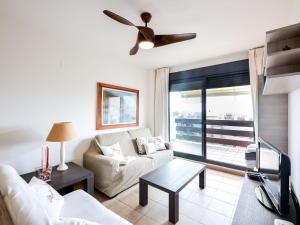 a living room with a couch and a ceiling fan at Apartment Alamar by Interhome in Mijas Costa