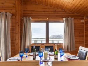 a dining room with a table with wine glasses at Chalet Loch Leven Lodge 12 by Interhome in Kinross +32 photos
