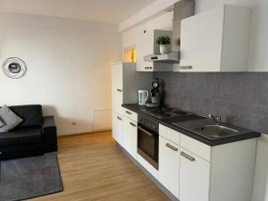 a kitchen with a sink and a stove top oven at Casa Blanca am Herzzentrum Lahr in Lahr