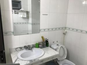 a bathroom with a sink and a toilet and a mirror at ANH ANH HOTEL in Bắc Hà
